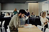 Man working solitary in office cafeteria\n