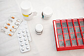 Various pills and medications at table\n