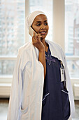 Junge Ärztin im Telefongespräch bei der Arbeit