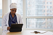 Young female doctor using tablet at work\n