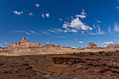 Window Blind Peak, left, & Assembly Hall Peak, right, Mexican Mountain Wilderness Study Area on the San Rafael Swell in Utah. Overhead are both cumulus and high streaking cirrus clouds.\n