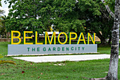 A sign for the city of Belmopan in a park. Cayo District, Belize.\n