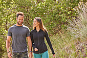 Mid adult couple hiking in forest\n