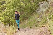 Mid adult woman jogging outdoors\n