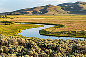 USA, Idaho, Bellevue, Silver Creek stream flowing through farmland\n