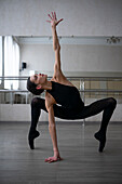 Ballerina dancing in dance studio \n