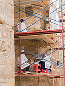 Workers at the Karnak Temple Complex, a vast mix of temples, pylons, chapels, and other buildings, Luxor, Thebes, Egypt, North Africa, Africa\n