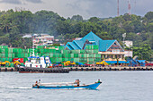 Boat and containers in the harbor in the city of Sorong, the largest city and the capital of the Indonesian province of Southwest Papua, Indonesia, Southeast Asia, Asia\n
