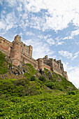 Bamburgh Castle, a hilltop fortress constructed on top of a craggy outcrop of volcanic dolerite, Grade I Listed Building, Bamburgh, Northumberland, England, United Kingdom, Europe\n