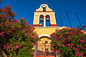 View of church bell tower overlooking Fiscardo harbour, Fiscardo, Kefalonia, Ionian Islands, Greek Islands, Greece, Europe\n