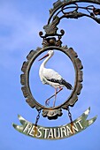 France, Haut Rhin, Riquewihr, labeled Les Plus Beaux Villages de France, restaurant sign, a stork\n