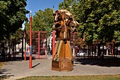 France, Nord, Lille, Jean Baptiste Lebas park with characteristic red grilles, statue as part of Lille 3000 expo Eldorado\n