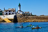 France, Finistere, Ile de Sein, kayak in the harbour in front of the Men-Brial lighthouse\n