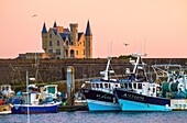 France, Morbihan, wild coast, Quiberon peninsula, fishing boats from Port Maria in line with the Turpault castle\n