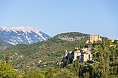 France, Drôme, regional natural park of Baronnies provençales, Montbrun-les-Bains, labeled the Most Beautiful Villages of France, the village and the Renaissance castle of Dupuy-Montbrun, Mont Ventoux in the background\n