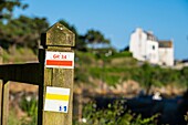 France, Finistere, Clohars-Carnoet, the picturesque fishing port of Doëlan, marking of GR 34 hiking trail or customs trail\n
