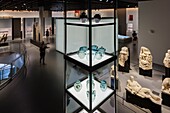 France, Gard, Nimes, Musee de la Romanite by architect Elizabeth de Portzamparc, glass funeral urns and statuary group from Beaucaire road\n
