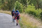 France, Lot, two women pilgrims to Saint-Jacques de Compostelle on GR65 trail,area of Les Mazuts village\n