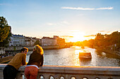 France, Paris, area listed as World Heritage by UNESCO, Rives de Seine Park, a cup on the Sully bridge at sunset\n