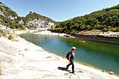 France, Ardeche, Sauze, Ardeche Gorges natural national reserve, Female hiker on the downstream path of the Ardeche Canyon between Gournier bivouac and Sauze\n
