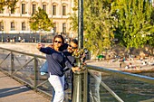 France, Paris, area listed as World Heritage by UNESCO, selfie tourists on the Pont des Arts\n
