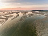 France, Somme, Baie de Somme, Le Hourdel, The tip of the Hourdel and the sand banks of the Baie de Somme at low tide (aerial view), the channel of the Somme extends to the sea\n