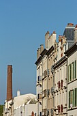 France, Meurthe et Moselle, Nancy, facades of apartment buildings and red bricks chimney in Rue Charles the Third (Charles the Third street)\n