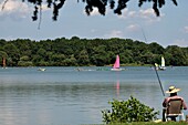 France, Territoire de Belfort, Belfort, Etang des Forges in summer, fisherman, nautical activities, sailboats\n
