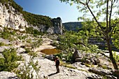 France, Ardeche, Ardeche Gorges National Natural Reserve, Sauze, Female hiker above Ardeche river, on the path of the Louby valley\n