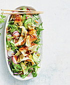 Asian dumpling salad with radishes