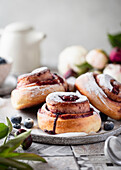Blueberry buns made from yeast dough with icing sugar