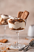 Banoffee pie dessert in a glass with lotus biscuits