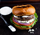 Lamb burger with feta salad and tzatziki