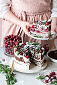 Cranberry crêpe cake with whipped cream and rosemary