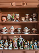 Collection of porcelain figurines and doll heads