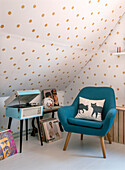 Corner in the attic with blue colored armchair, vinyl records and record player