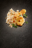 Bowl of rice pudding and apple slice on serving dish