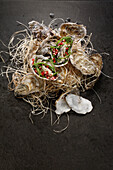 Oysters with seaweed and pomegranate seeds