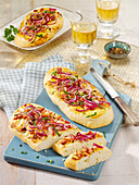 Tarte flambée ciabatta with bacon and red onions