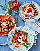 Poppy seed waffles with strawberry and blackcurrant salad