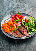 Rice noodle and vegetable bowl with steak