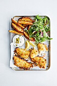 Fish and chips on a baking sheet