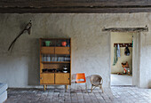 Mid-Century Bücherschrank im rustikalen Ambiente mit Holzbalkendecke