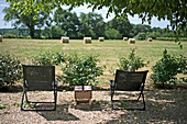 Chairs on gravel terrace with landscape view