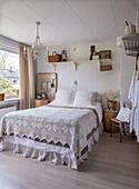 Country-style bedroom with crocheted bedspread and wooden accessories