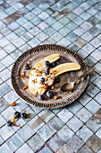 Muesli breakfast with banana, roasted seeds and yogurt (vegetarian)