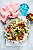 Steak tacos with spring onions and salsa
