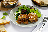 Vegan bean patties with gravy and salad