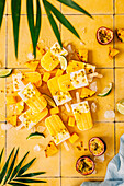Mango and coconut popsicles with passion fruit