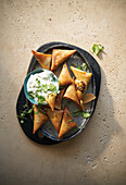 Hot potato curry samosas with herb yogurt